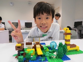 A lower primary student showcasing his zoo model