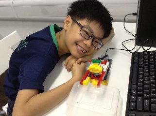 A student showcasing his LEGO® drumming monkey